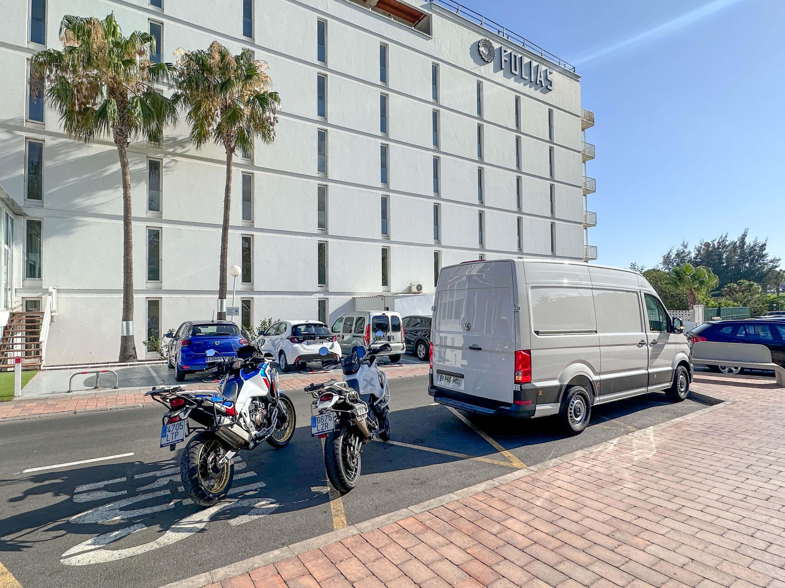 Two motorcycles and the Canary Ride support van delivered to a hotel entrance