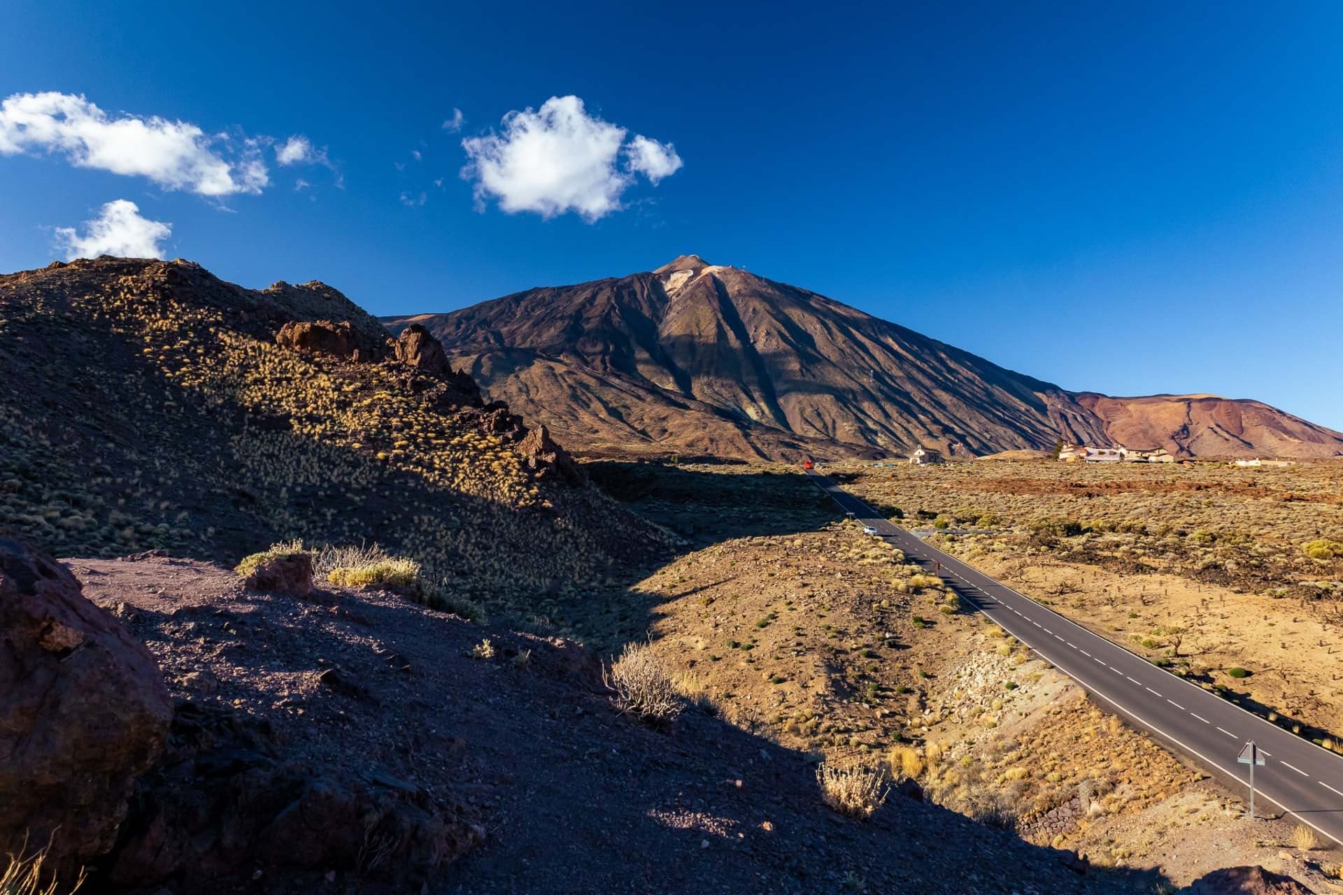 Straight open road across volcanic terrain towards Mount Teide, Tenerife